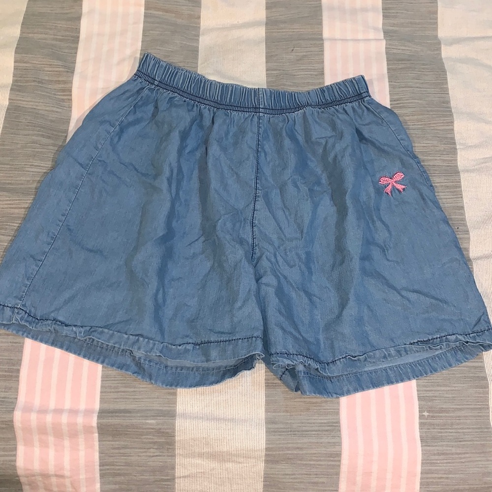 Light blue faux denim shorts with pink embroidered bow